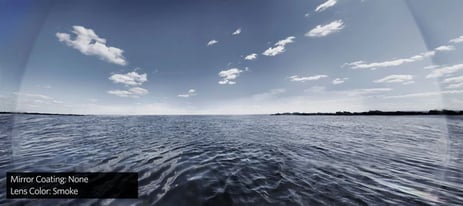 View of open water, a blue sky wearing sunglasses
